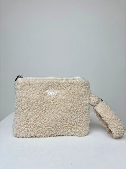 Beige teddy pouch with a visible brand logo on a light gray background